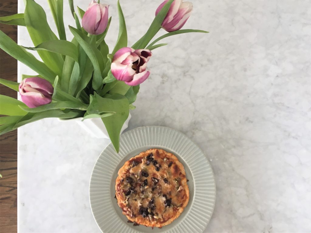 Spring time entertaining is made easy with this healthy weight watchers approved olive pizza! Check out my easy two-ingredient dough that you can make in three minutes, and tastes delicious!